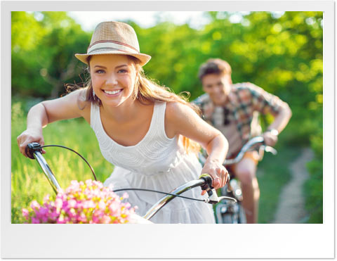 Woman riding a bike with a basket full of flowers